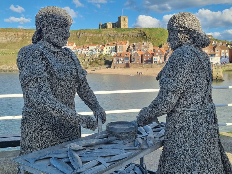 Whitby herring girls statue celebrating fishing history. Whitby herring girls statue celebrating fishing history.