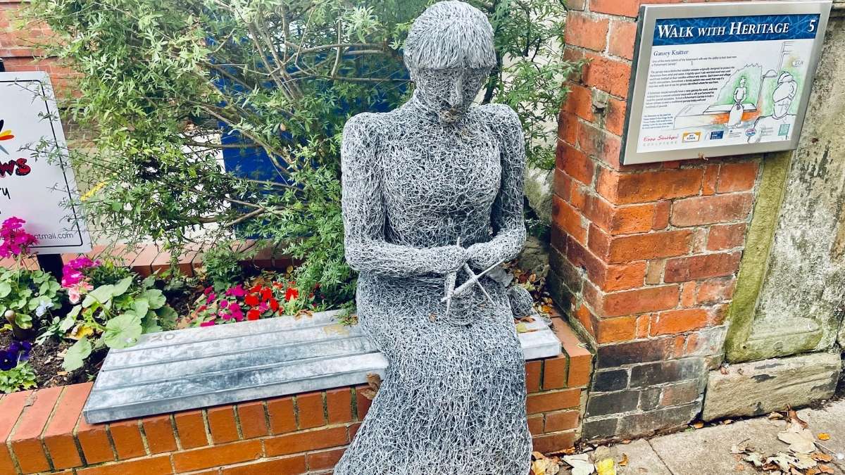 Gansey knitter sculpture of a woman knitting