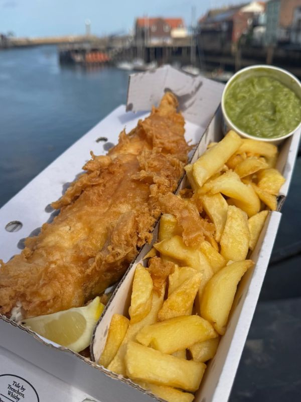 Trenchers fish and chips in a take away. Trenchers fish and chips in a take away.