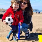 Toddler Playing On The Beach
