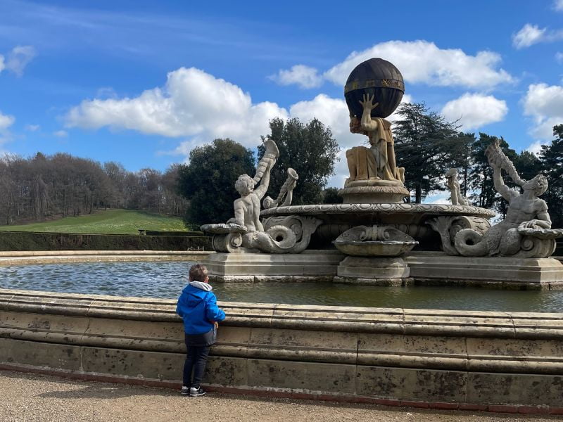 Child at Castle Howard fountain on a family day out.