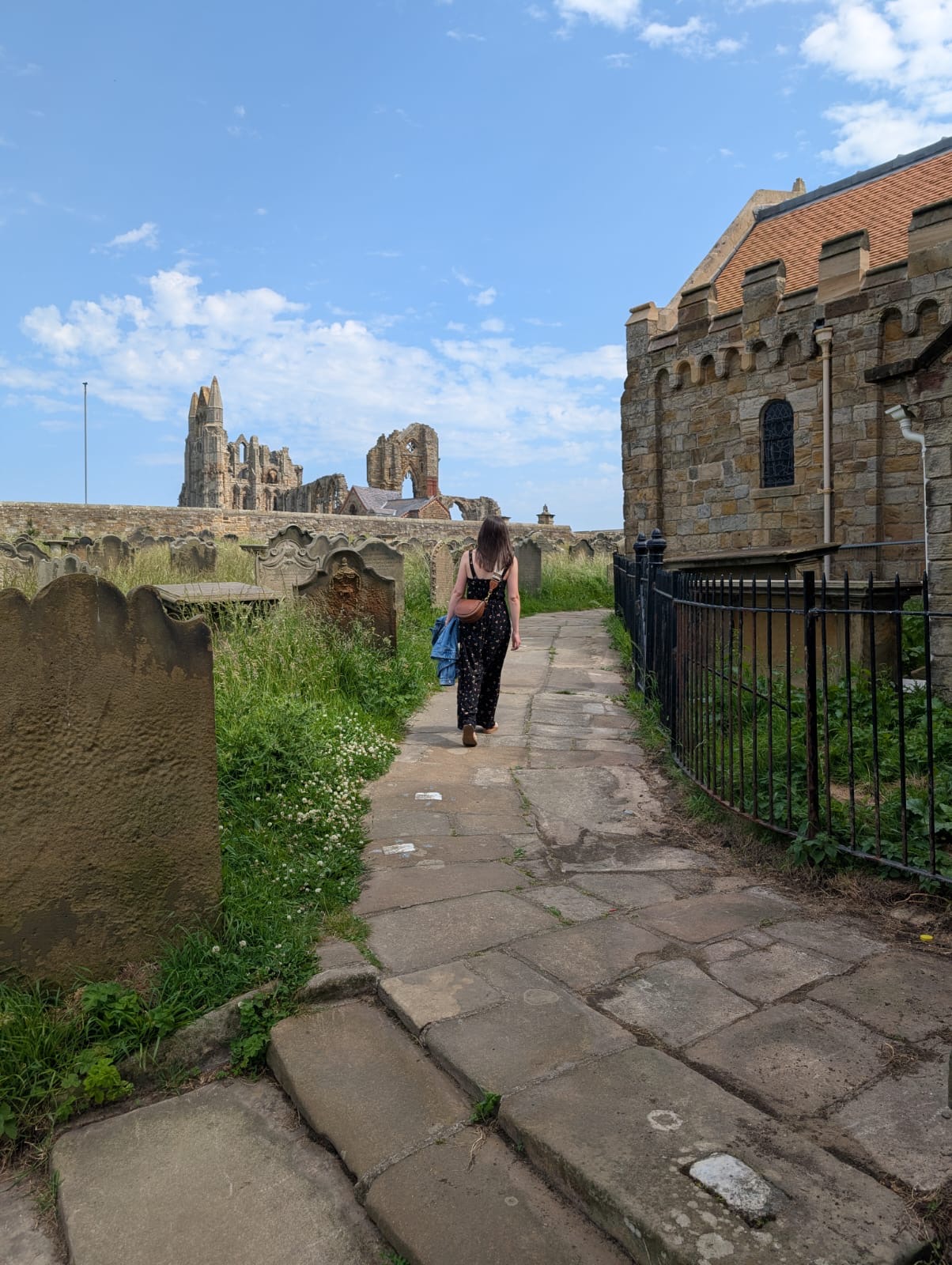 Girl walking towards Whitby Abbey.