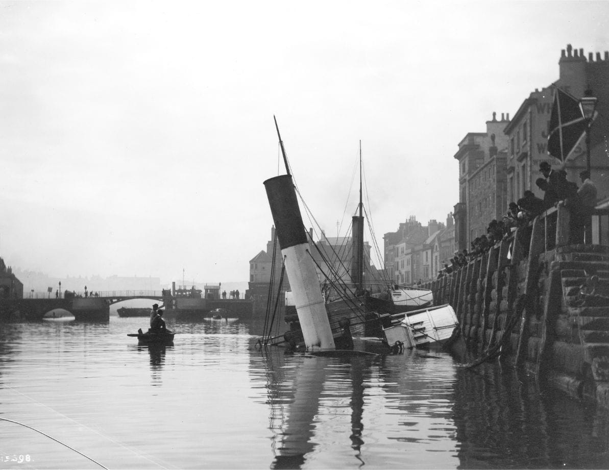 Frank Meadow Sutcliffe's photograph of a Paddle Steam Tug sinking in Whitby Harbour, year 1872