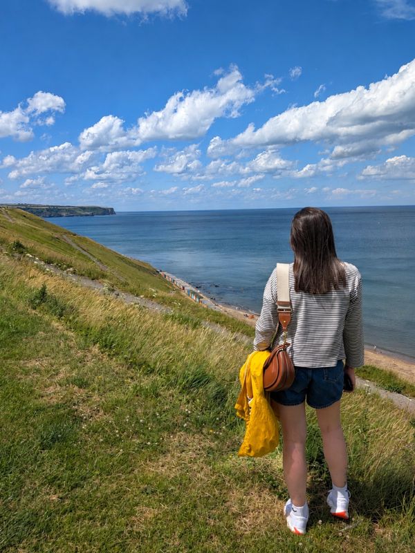 Girl heading out on a walk from Whitby to Sandsend. Girl heading out on a walk from Whitby to Sandsend.